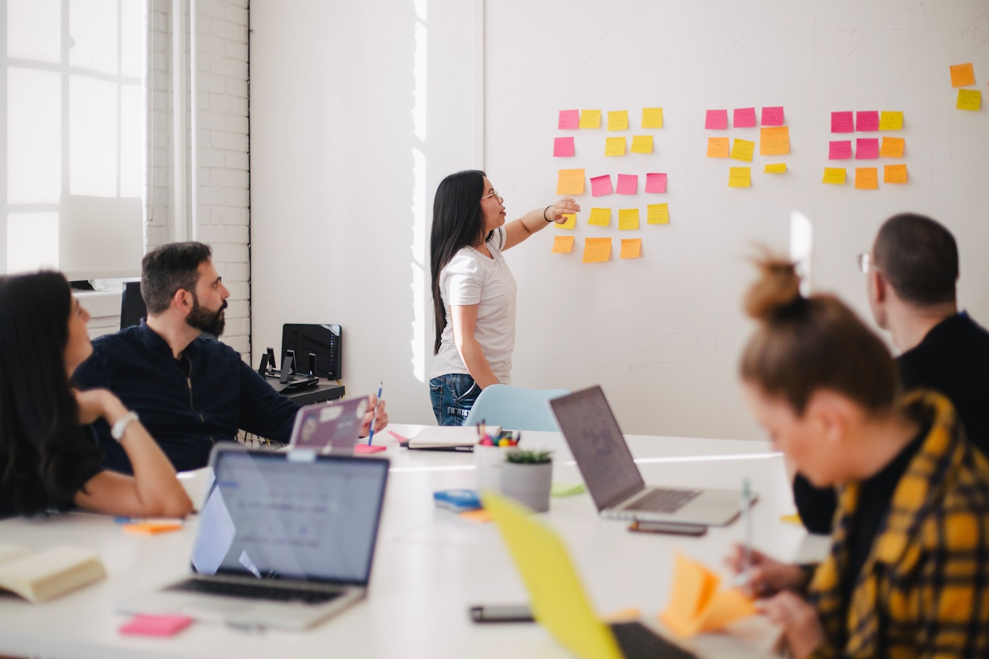 Instructor mapping AI budget workflow modules on a whiteboard